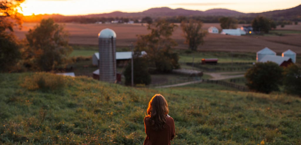 Woman looking out at farm land